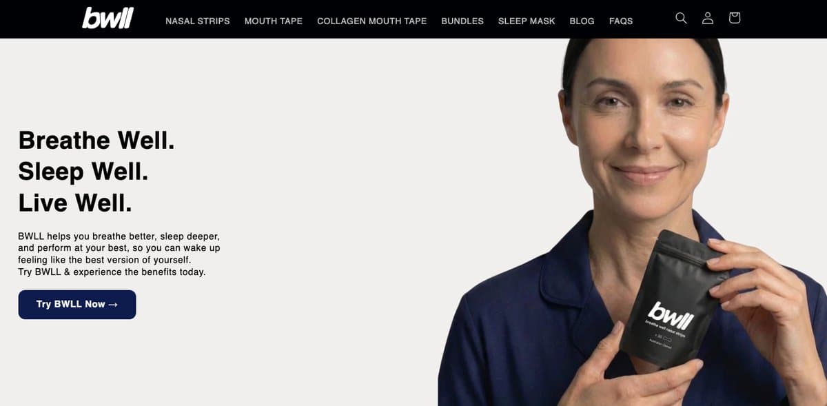 The BWLL homepage hero, showing a woman holding a BWLL nasal strip pouch beside the headline Breathe Well. Sleep Well. Live Well.