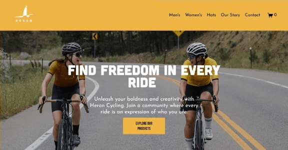The Heron Cycling homepage hero, showing two cyclists on a mountain road under the headline Find Freedom In Every Ride
